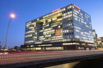 Mirror building on Ericusspitze Hamburg at blue hour with light strips and light trails from