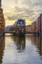 Water castle in the Speicherstadt Hamburg on a wall frame fleet with clouds in the background at