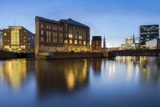 View from Oberbaum Bridge of the Zollkanal and Teerhof at blue hour with reflections in the water