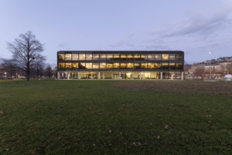 The state parliament of Stuttgart glows impressively in the evening. The architecture is
