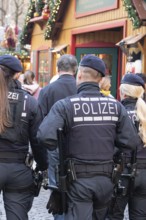 Three police officers are patrolling the Stuttgart 2025 Christmas market. Their presence ensures