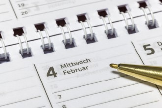 Close-up of a calendar on Wednesday, February 4 with ballpoint pen, appointment calendar