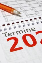 Diary with red lettering and orange pen, diary