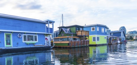 Colorful floating homes reflecting in the calm water in fisherman's wharf park, a popular tourist