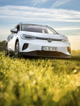 Silver car on green field at morning light, VW ID4 electric car, Deer Carsharing, Calw, Germany