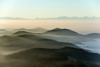 View from Belchen heading south of Wiesental and the Swiss Alps, morning atmosphere with fog in