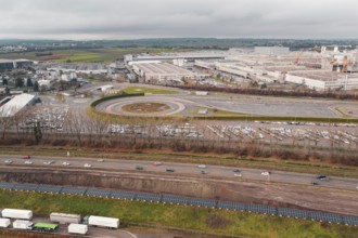 Extensive Daimler Benz industrial area with roads and parking lots under a cloudy sky, Böblingen,