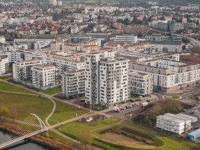 Large residential buildings and bridge across a river in an urban landscape, Böblingen airfield,