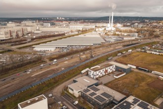 Industrial area with chimneys and factory buildings under a cloudy sky, A81, Böblingen, Germany