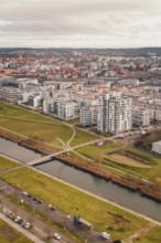 Large residential complex with modern buildings on a canal and adjacent green spaces, Böblingen,