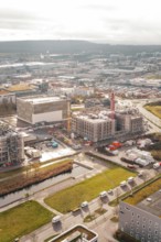 New hospital building Municipal construction site with several buildings and cranes next to green