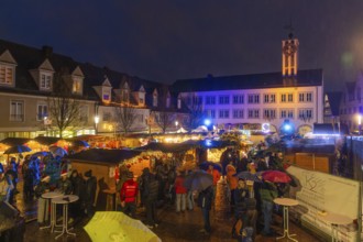 Busy Christmas market at night with bright lights and rainy atmosphere, Böblingen Christmas market,