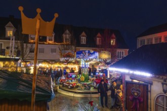 Overview of a Christmas market with crown, carousel and festive lighting at night, Böblingen