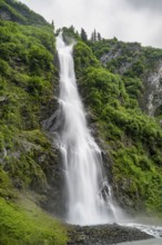 Horsetail Falls waterfall on the Lowe River in a green gorge, long exposure, Keystone Canyon,
