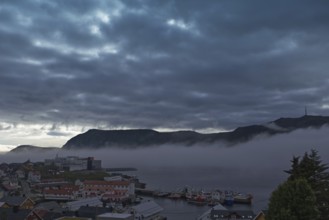 City scene in gloomy weather with fog over the water, Honningsvag