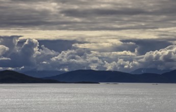 Wide expanse of water under a blanket of thick clouds, Norway