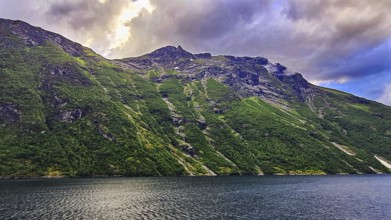 Mountain landscape with clouds and a quiet fjord, Norway