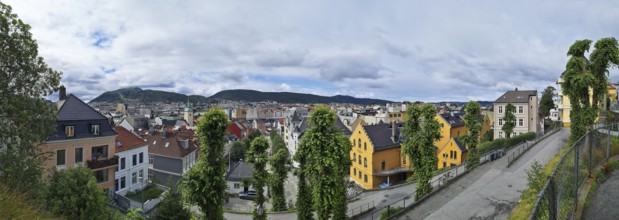 Panorama of the city of Bergen with yellow and white houses and lush greenery, Bergen Norway