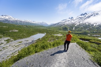 Female hiker on glacial moraine, view of the vast Tsina River valley with mountains, Worthington