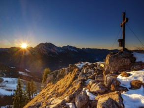 Summit cross of the board fork at sunset, in the back Watzmann, Hochkalter and Reiteralpe,