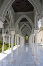 Impressive marble in an arcade under a blue sky with carved details on the pillars, Rabati
