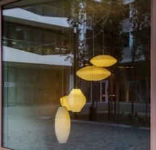 Ceiling lights, looking through the shop window into the interior of a furniture store, Berlin,