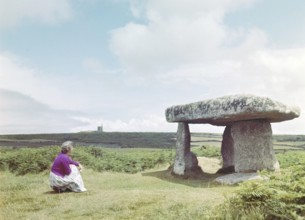 Woman visiting Lanyon Quoit, prehistoric Neolithic chambered tomb, Cornwall, England, UK, c 1960