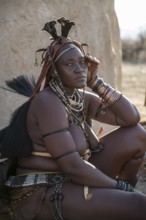 Decorated Himba woman in front of cottage, traditional Himba village, Kaokoveld, Kunene, Namibia