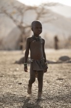 Himba child running in the village, traditional Himba village, Kaokoveld, Kunene, Namibia