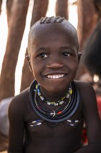 Portrait, grinning Himba child, traditional Himba village, Kaokoveld, Kunene, Namibia