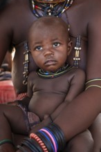 Himba woman with baby, traditional Himba village, Kaokoveld, Kunene, Namibia