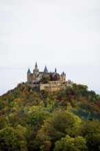 Castle and autumnal forest, Hohenzollern Castle, Hechingen, Swabian Jura, Baden-Württemberg,