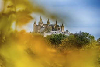Castle and autumnal forest, Hohenzollern Castle, Hechingen, Swabian Jura, Baden-Württemberg,