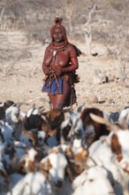 Himba woman taking care of goats, traditional Himba village, Kaokoveld, Kunene, Namibia