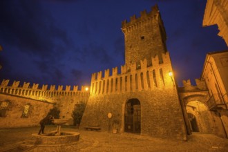 The castle and defensive walls illuminated, Borgo di Vigoleno, Vernasca, Province of Piacenza,
