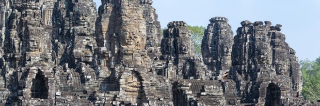 Panoramic picture of huge stone-carved faces of Bodhisattva Lokeshvara, also Avalokiteshvara, Bayon