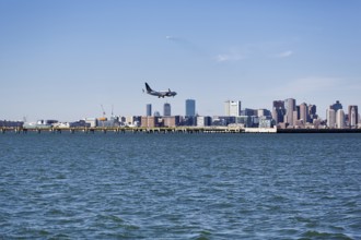 Boston skyline with an airplane landing at Logan International Airport, Boston, Massachusetts, New