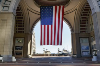 American flag fluttering, distinctive archway, Boston Harbor Hotel, Rowes Wharf, Freedom Trail,