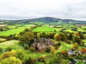 Autumn Colours over ruins of Grosmont Castle from a drone, Grosmont, Monmouthshire, Wales, UK
