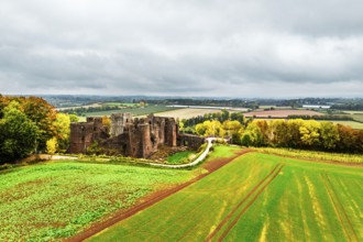Autumn Colours over ruins of Goodrich Castle and River Wye from a drone, Goodrich, Herefordshire,