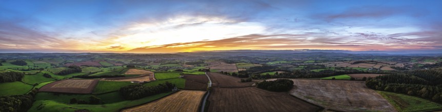 Sunset of Devon Farms and Fields over Berry Pomeroy from a drone, Totnes, England, United Kingdom