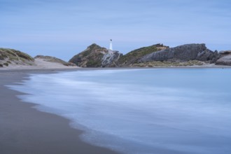 Deliverance Cove and Castlepoint Lighthouse on the rock, ocean, long exposure, evening.