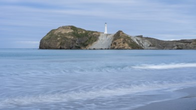 Castlepoint Beach with lighthouse on the rock, ocean, long exposure. Castlepoint, Wairarapa Coast,
