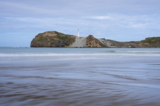 Castlepoint Beach, ocean and lighthouse on a rock, long exposure. Castlepoint, Wairarapa Coast,