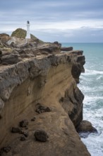 Castlepoint lighthouse on a rock, ocean. Castlepoint, Wairarapa Coast, Wellington Region, North