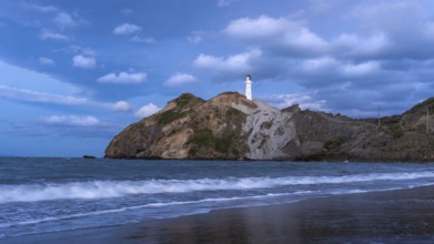 Castlepoint Beach, ocean and lighthouse on a rock, in the evening, after sunset. Castlepoint,