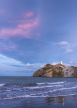 Castlepoint Beach, ocean and lighthouse on a rock, in the evening, after sunset. Castlepoint,