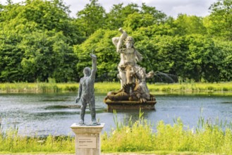 Bronze sculpture of painter's trunk and mirror pond with Hercules in the baroque Neuwerkgarten,