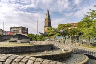 Fountain on Europaplatz and the tower of the town hall in Kiel, Schleswig-Holstein, Germany