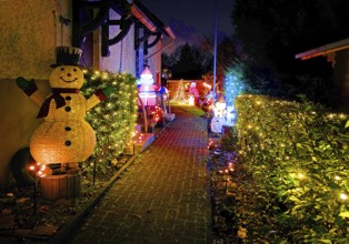 Christmassy kitschy illuminated entrance of a terraced house in Gelsenkirchen-Ückendorf in the